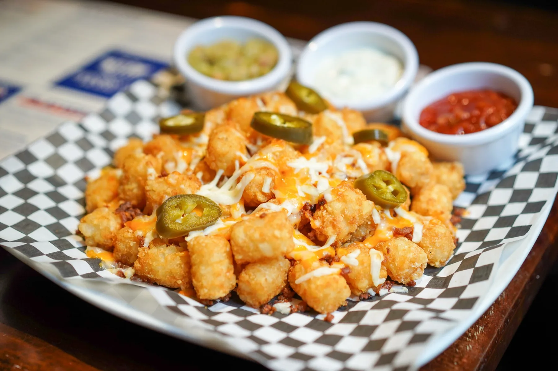 Supreme tater tots with jalapenos and dipping sauces